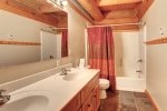 Deer Haven Lodge with main bath with dual sinks and show/tub combo.